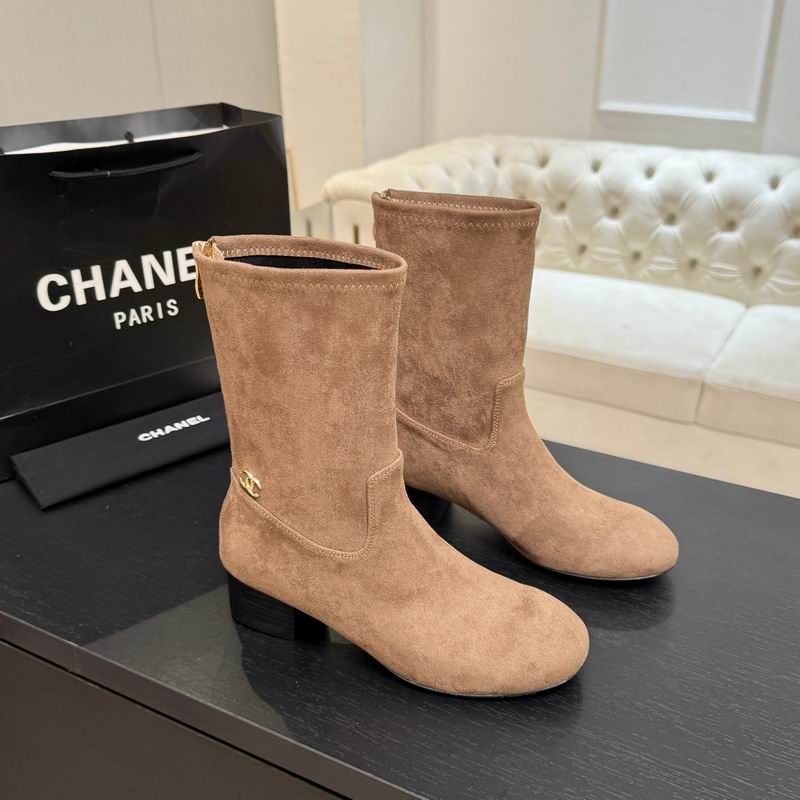 Chanel beige suede ankle boots with gold CC hardware and block heel, displayed with Chanel Paris shopping bag